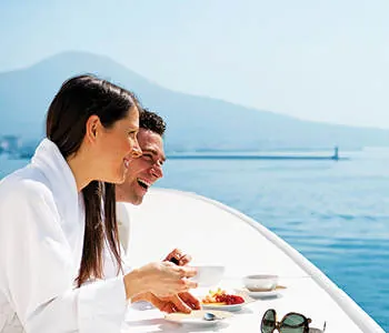A couple sharing breakfast on a boat