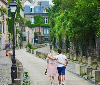 A couple walking down a quiet cobbled street